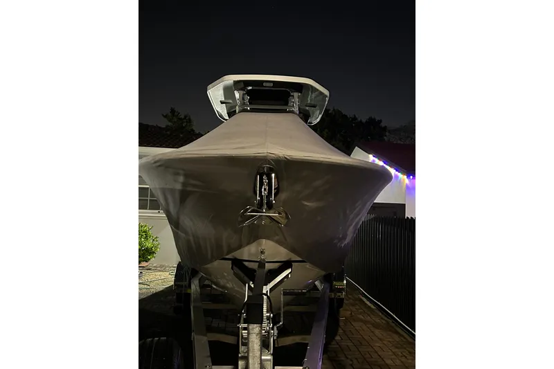 Slide: The Image of 2021 Blackfin 252 CC boat covered and parked at night. - 17