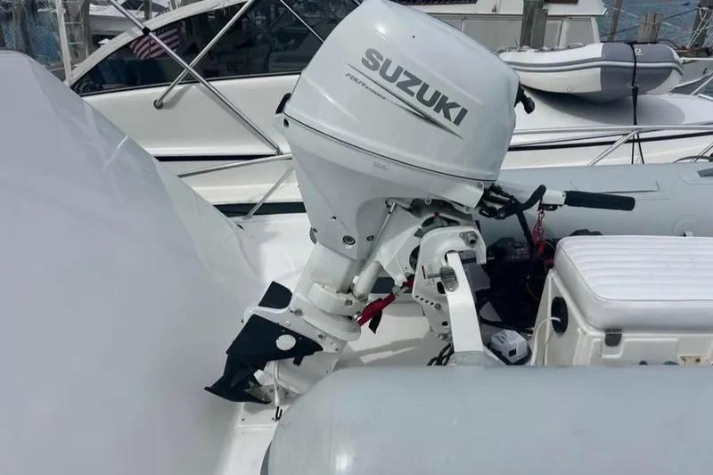 Slide: The Image of 2022 AB Inflatables Navigo 12 VS with Suzuki outboard motor, docked at marina. - 1