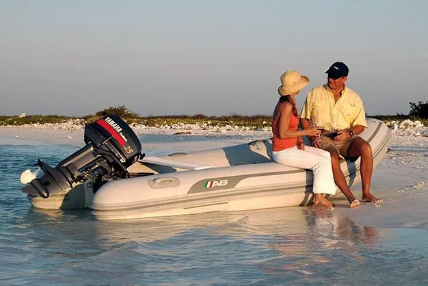 Slide: The Image of Manufacturer Provided Image: 2022 AB Inflatables Navigo 12 VS boat on a beach with two people. - 11