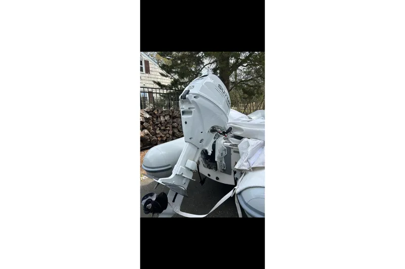 Slide: The Image of 2022 AB Inflatables Navigo 12 VS with Suzuki outboard motor, parked outdoors. - 17