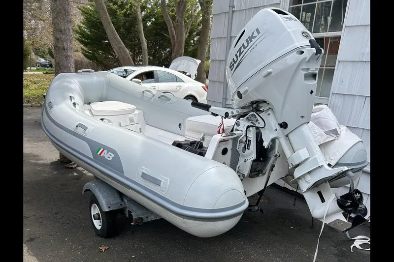 Slide: The Image of 2022 AB Inflatables Navigo 12 VS with Suzuki outboard motor on trailer. - 19