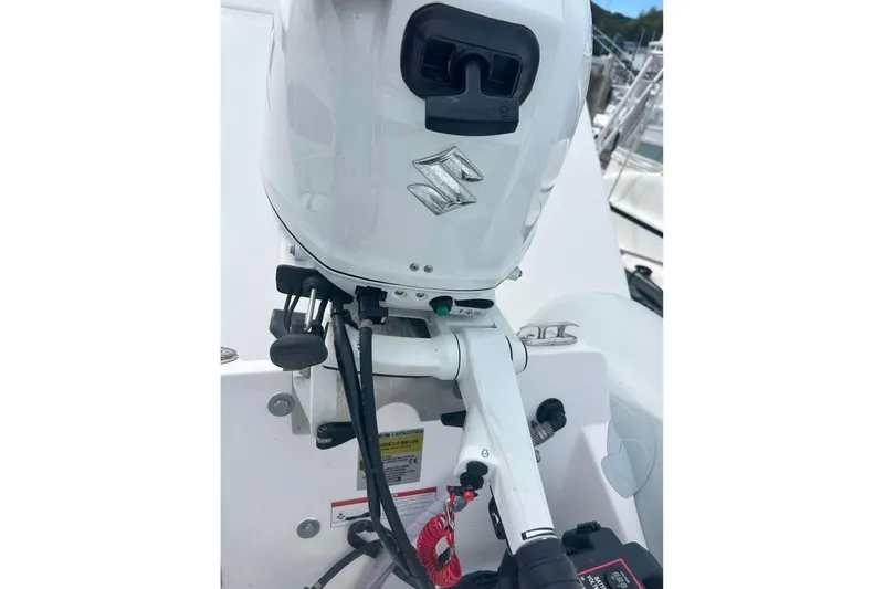 Slide: The Image of 2022 AB Inflatables Navigo 12 VS with Suzuki outboard motor, docked at marina. - 3