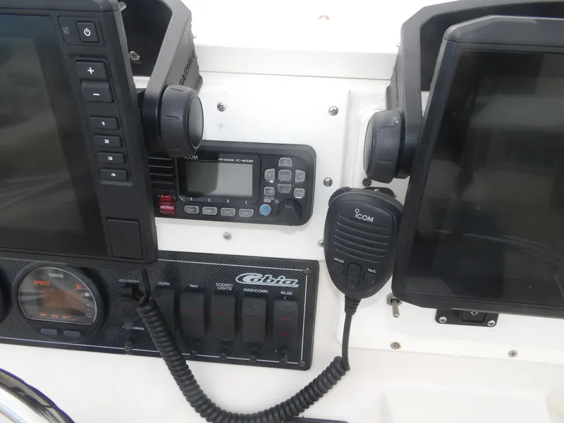 Slide: The Image of Dashboard of a 2006 Cobia 214 Center Console boat with electronics. - 14