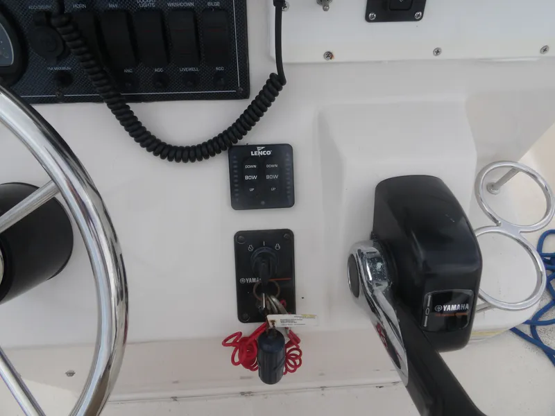 Slide: The Image of Control console of a 2006 Cobia 214 Center Console boat. - 15
