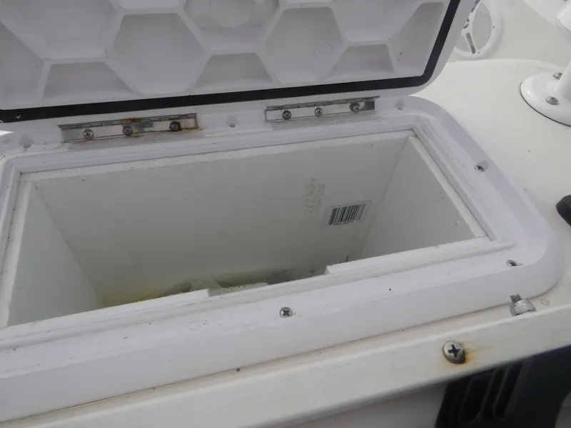 Slide: The Image of Open storage compartment on a 2006 Cobia 214 Center Console boat. - 16