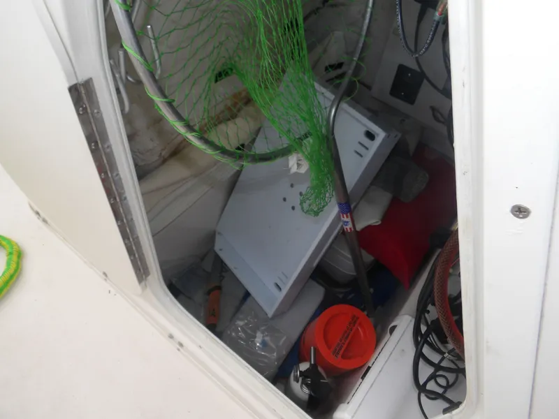 Slide: The Image of Storage compartment of a 2006 Cobia 214 Center Console boat with fishing gear. - 17