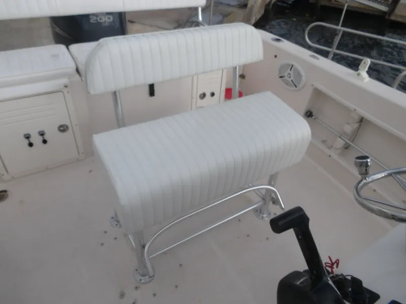 Slide: The Image of Interior of a 2006 Cobia 214 Center Console boat with white upholstery. - 29