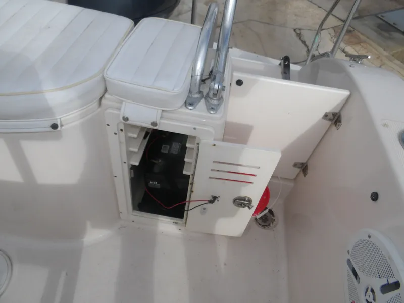 Slide: The Image of Open battery compartment on a 2006 Cobia 214 Center Console boat. - 31