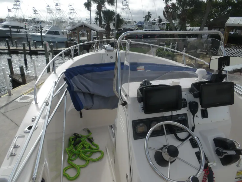 Slide: The Image of 2006 Cobia 214 Center Console boat at dock with equipment. - 35