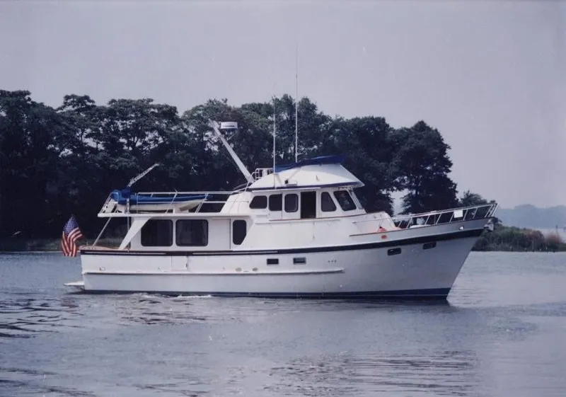 Slide: The Image of 1987 DeFever 49 Pilothouse yacht on calm water. - 2