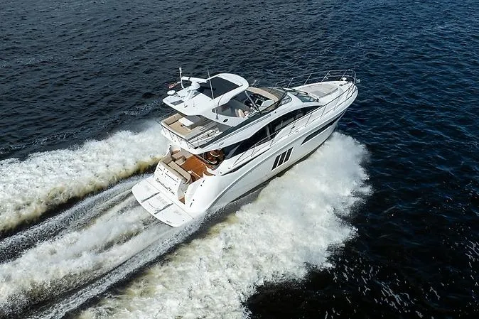 The Image of 2016 Sea Ray 510 Fly yacht cruising on open water, aerial view. - 0
