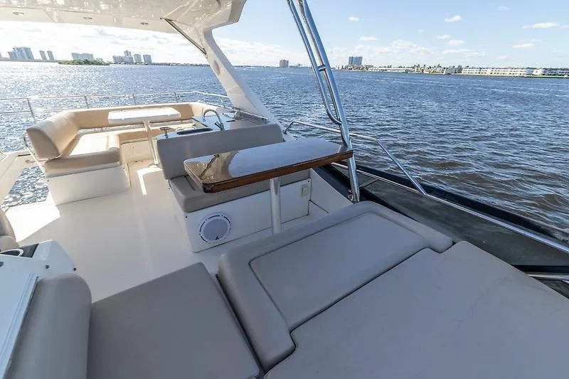 Slide: The Image of Luxurious 2016 Sea Ray 510 Fly yacht with spacious deck overlooking serene waters. - 13