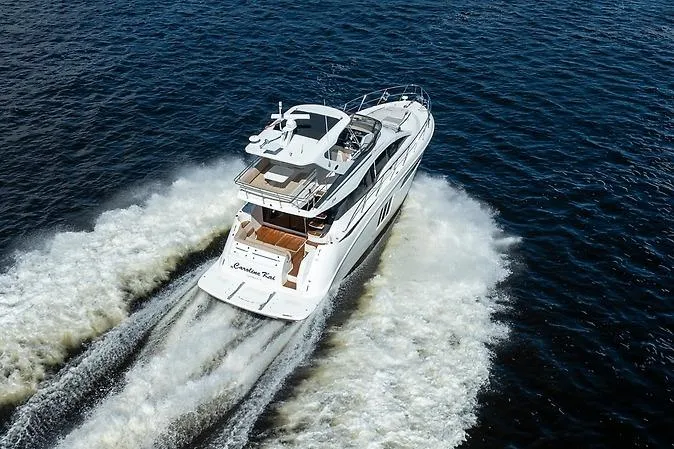Slide: The Image of 2016 Sea Ray 510 Fly yacht cruising on open water, aerial view. - 2