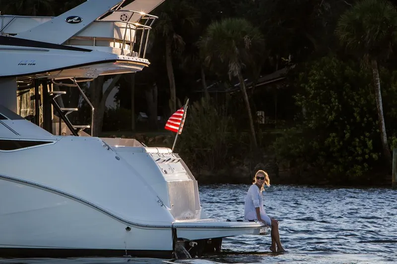 Slide: The Image of Manufacturer Provided Image: 2016 Sea Ray 510 Fly yacht with person relaxing on swim platform. - 22