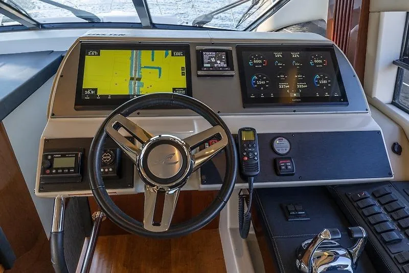 Slide: The Image of 2016 Sea Ray 510 Flybridge helm with advanced navigation and control systems. - 4