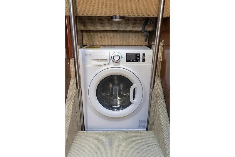 Slide: The Image of Washing machine inside 2016 Sea Ray 510 Fly yacht, compact laundry area. - 8