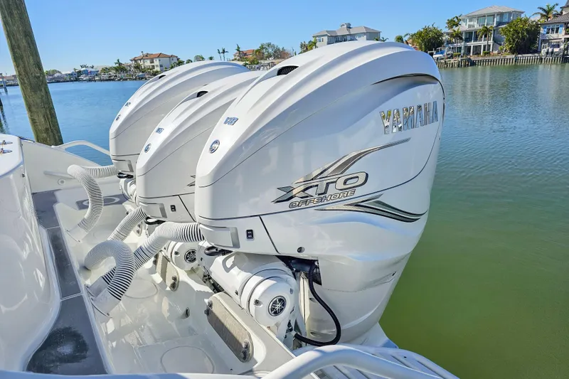 Slide: The Image of 2015 Yellowfin 42 Offshore boat with Yamaha XTO Offshore engines, docked by waterfront homes. - 6