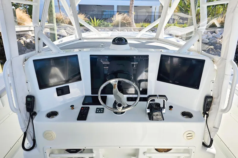 Slide: The Image of 2015 Yellowfin 42 Offshore boat dashboard with modern navigation equipment and controls. - 7