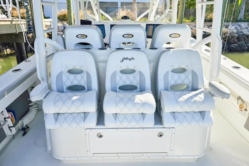 Slide: The Image of Luxurious seating on 2015 Yellowfin 42 Offshore boat, featuring white cushioned chairs. - 8