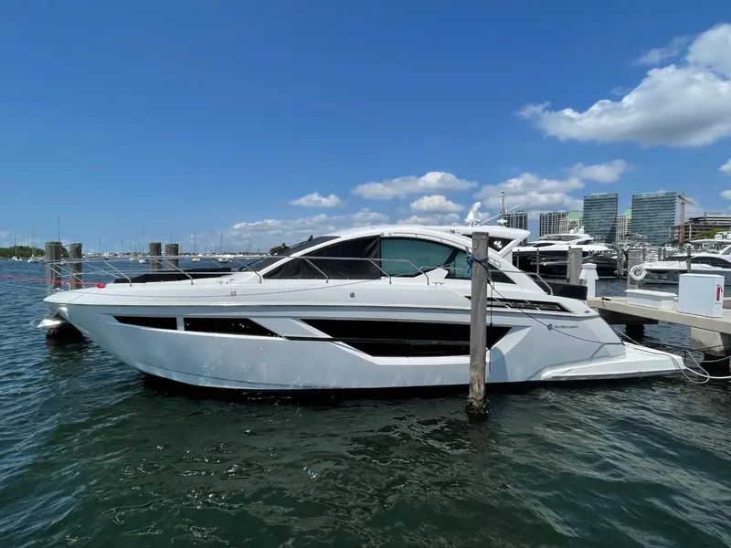 The Image of 2019 Cruisers 50 Cantius yacht docked in marina under clear blue sky. - 0