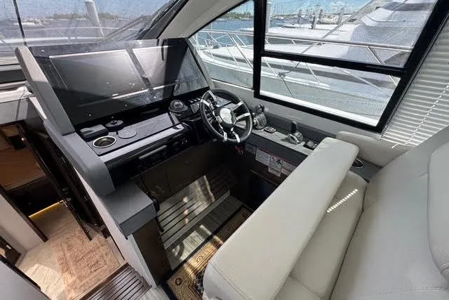 Slide: The Image of 2019 Cruisers Yachts 50 Cantius helm with modern controls and panoramic windows. - 17