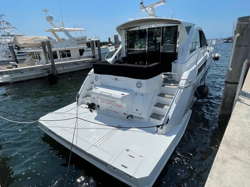 Slide: The Image of 2019 Cruisers 50 Cantius yacht docked at marina, rear view. - 2