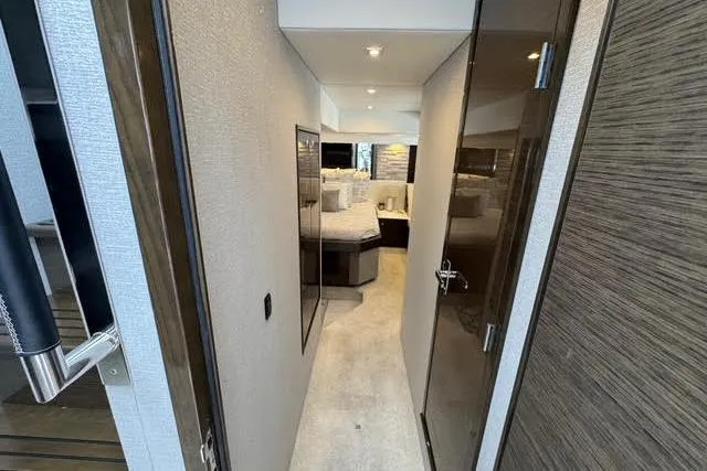 Slide: The Image of 2019 Cruisers Yachts 50 Cantius interior hallway leading to a luxurious bedroom. - 20
