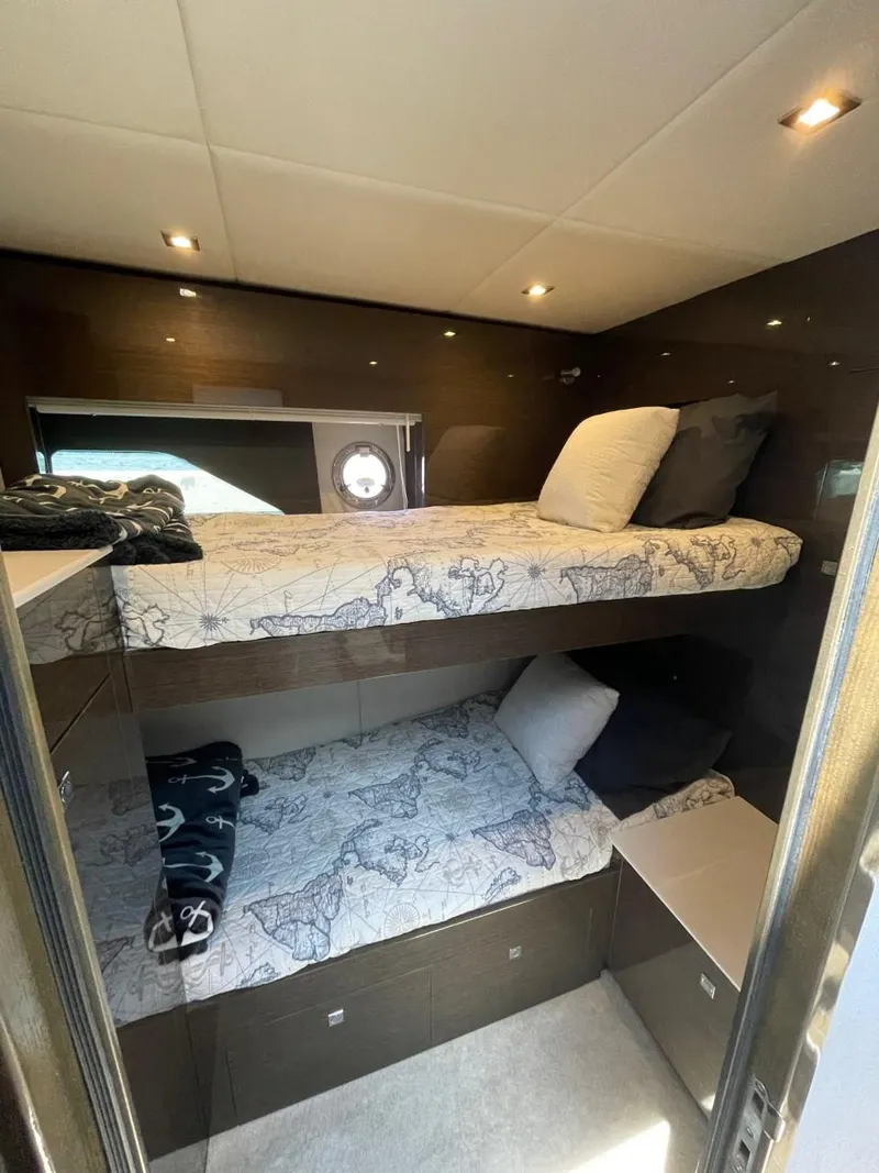 Slide: The Image of 2019 Cruisers 50 Cantius yacht interior with cozy bunk beds and modern lighting. - 29