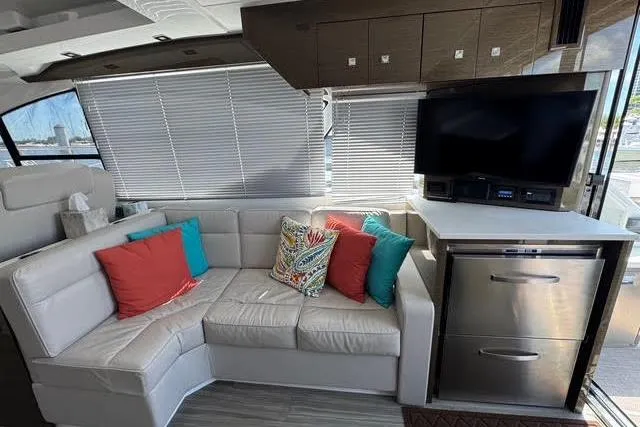 Slide: The Image of Luxurious 2019 Cruisers Yachts 50 Cantius interior with plush seating and modern entertainment system. - 12