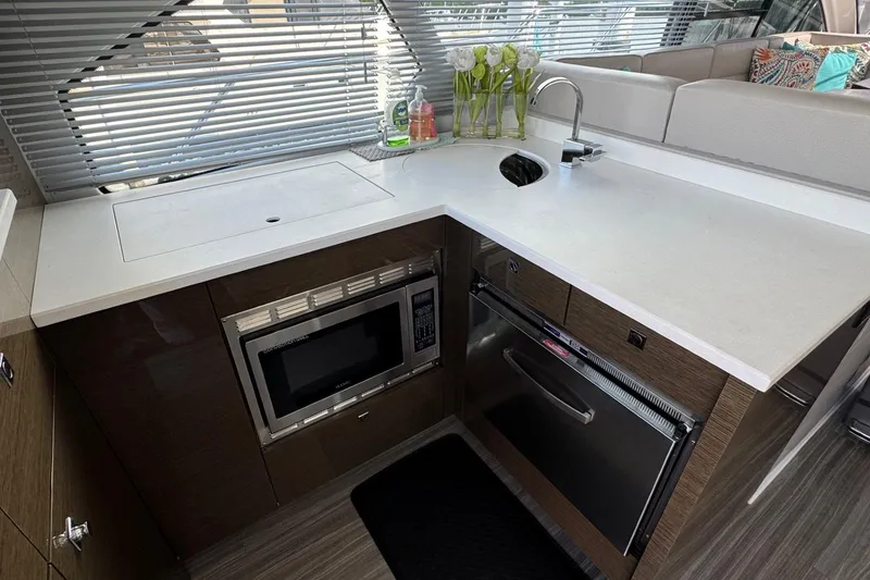 Slide: The Image of Modern kitchen area in 2019 Cruisers Yachts 50 Cantius with sleek appliances and stylish decor. - 14