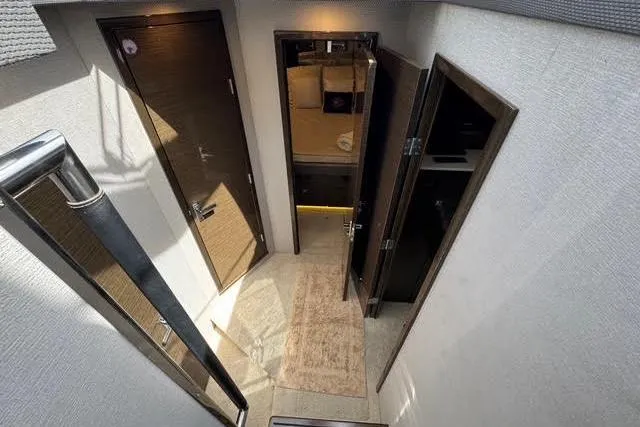 Slide: The Image of Interior view of 2019 Cruisers Yachts 50 Cantius, featuring hallway and cabin doors. - 18