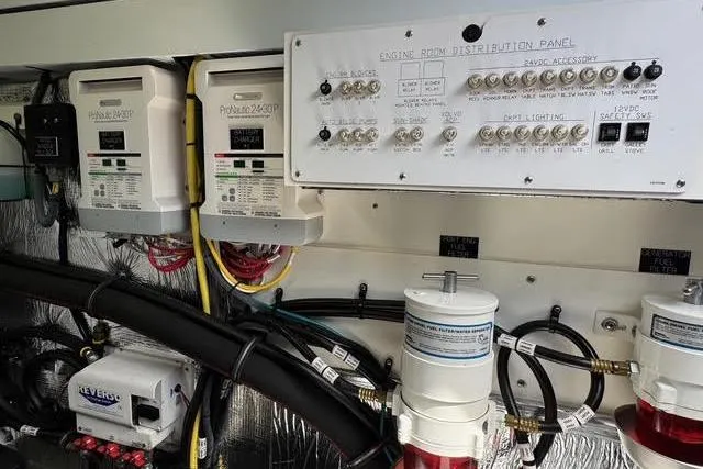 Slide: The Image of Engine room of 2019 Cruisers Yachts 50 Cantius with control panel and wiring. - 33