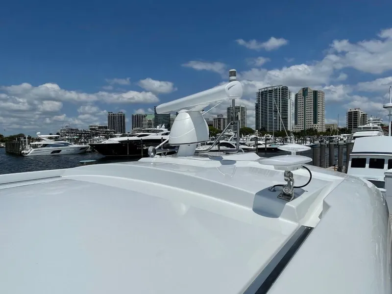 Slide: The Image of 2019 Cruisers 50 Cantius yacht docked in marina, city skyline in background. - 6