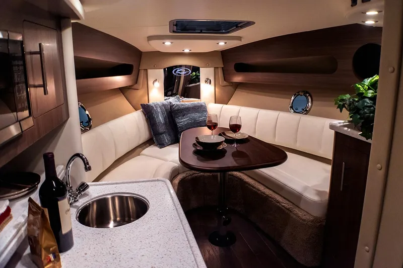 Slide: The Image of Manufacturer Provided Image: Luxurious interior of 2019 Rinker 290 EX boat with cozy seating and dining area. - 8