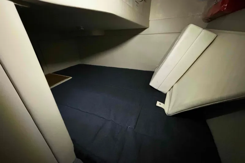 Slide: The Image of Interior cabin of 2011 Bayliner 285 Cruiser with cushions and storage space. - 14