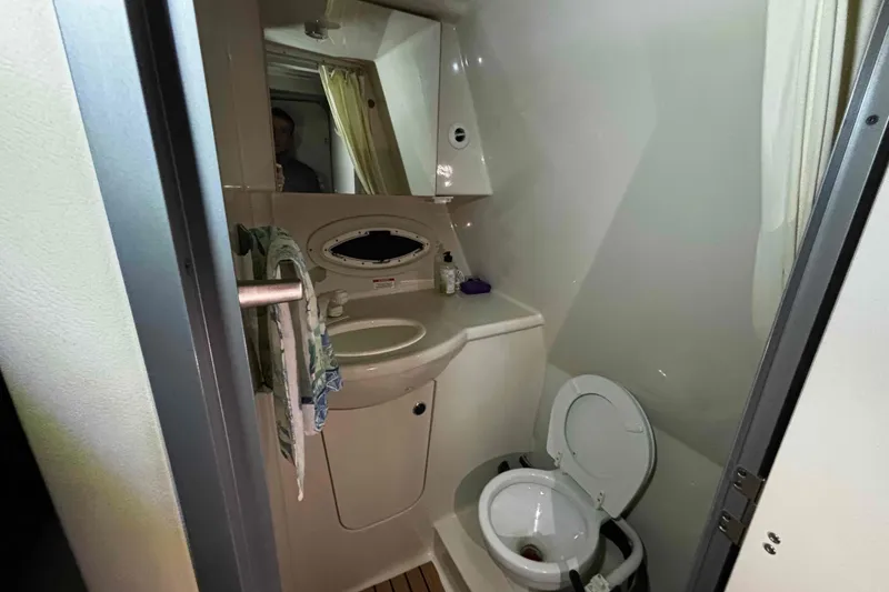 Slide: The Image of 2011 Bayliner 285 Cruiser bathroom with sink, toilet, and mirror. - 15