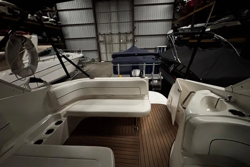 Slide: The Image of 2011 Bayliner 285 Cruiser interior with seating and sink in storage facility. - 7