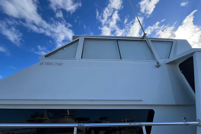 Slide: The Image of 1999 Viking 60 CPMY yacht against a blue sky with clouds. - 10