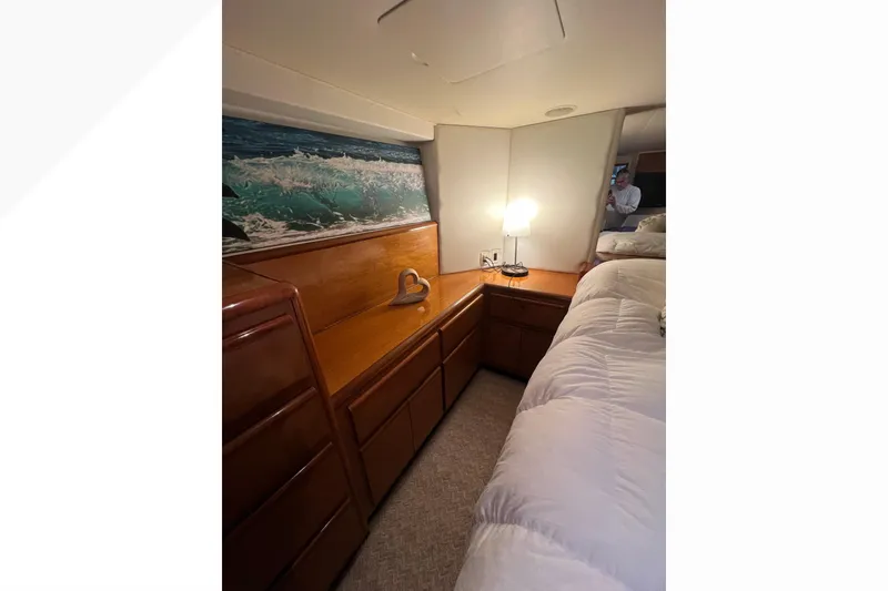 Slide: The Image of Cozy cabin interior of 1999 Viking 60 CPMY yacht with wooden cabinetry and soft lighting. - 101