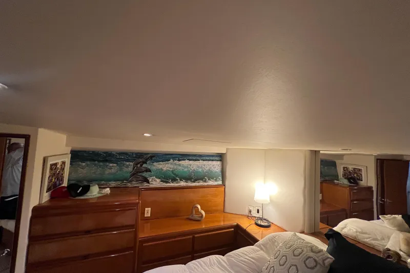 Slide: The Image of Cozy bedroom interior of 1999 Viking 60 CPMY yacht with ocean-themed artwork. - 102