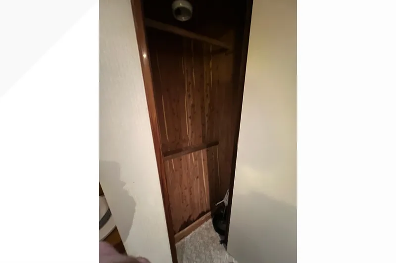 Slide: The Image of Wooden closet interior on a 1999 Viking 60 CPMY yacht. - 103