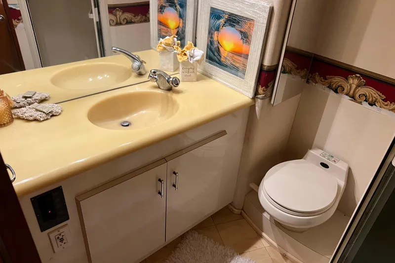 Slide: The Image of Luxurious bathroom in 1999 Viking 60 CPMY yacht with dual sinks and elegant decor. - 106
