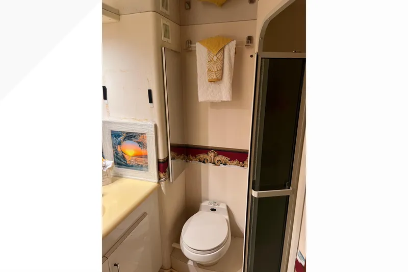 Slide: The Image of Bathroom interior of 1999 Viking 60 CPMY yacht with shower and decorative elements. - 108