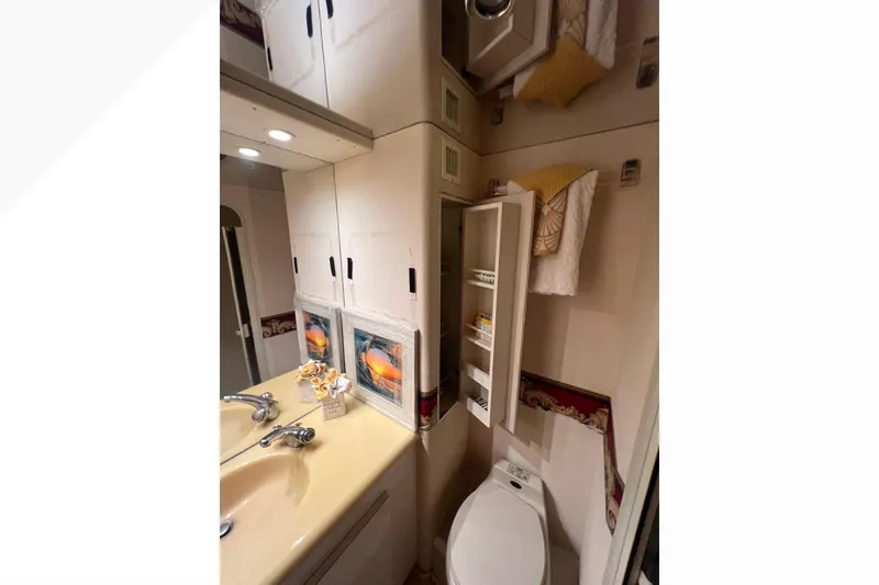 Slide: The Image of Bathroom interior of 1999 Viking 60 CPMY yacht with sink, mirror, and storage. - 111