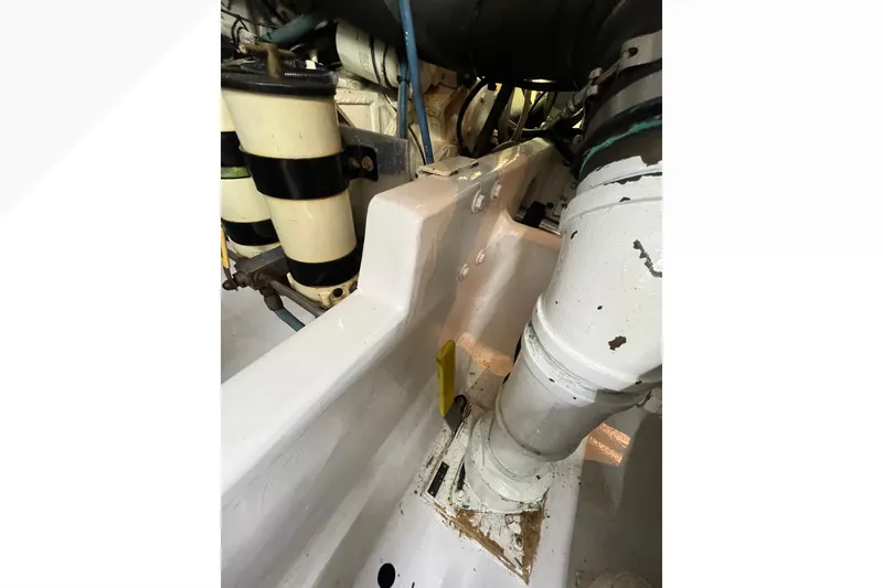 Slide: The Image of Engine room of 1999 Viking 60 CPMY yacht, showing mechanical components and piping. - 116