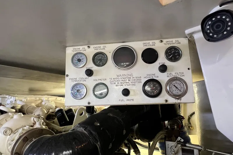 Slide: The Image of Control panel of a 1999 Viking 60 CPMY yacht engine room with gauges and warnings. - 124