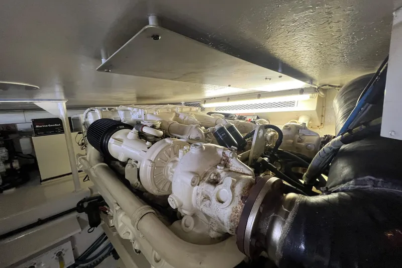 Slide: The Image of Engine room of a 1999 Viking 60 CPMY yacht, showcasing machinery and components. - 126