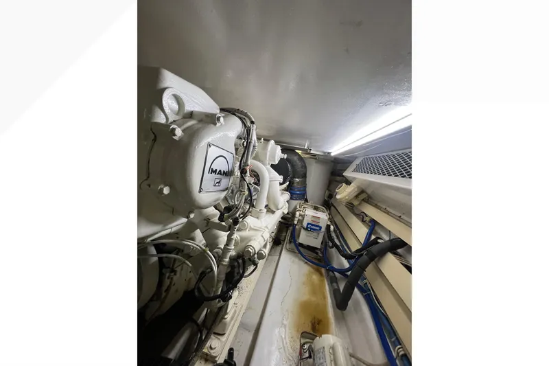 Slide: The Image of Engine room of 1999 Viking 60 CPMY yacht with MAN engine components. - 142