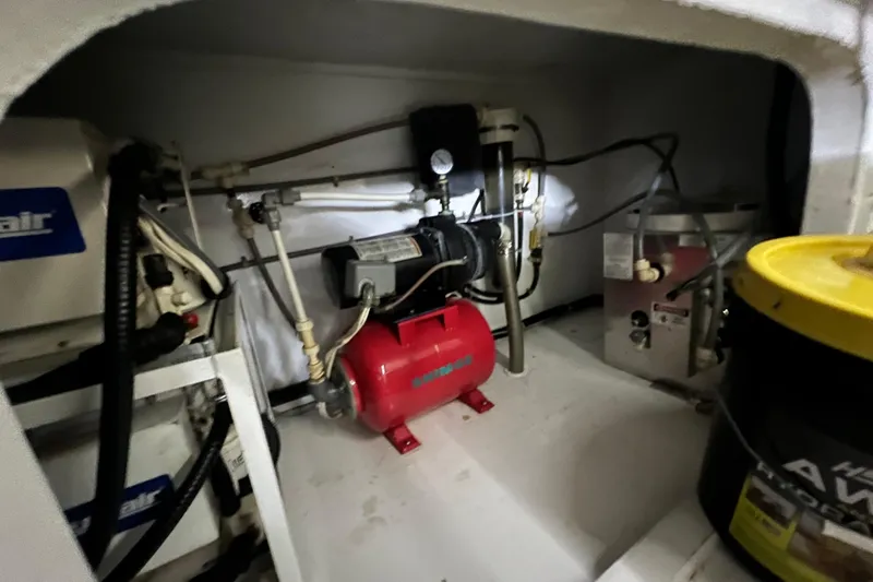 Slide: The Image of Engine room of 1999 Viking 60 CPMY yacht with mechanical equipment and storage. - 143
