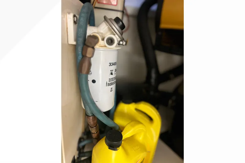 Slide: The Image of Fuel filter system in a 1999 Viking 60 CPMY engine room with yellow containers. - 146